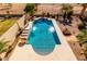 Aerial view of the pool featuring a waterfall, desert landscaping, and stone tile at 1213 W Deoni Trl, San Tan Valley, AZ 85143