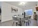 Modern dining room with glass table, seating for six, and decorative wall paneling at 12218 W Paso Trl, Peoria, AZ 85383