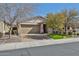 Charming single-story home with a well-maintained lawn, desert landscaping and inviting curb appeal at 12218 W Paso Trl, Peoria, AZ 85383