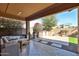 The patio has an outdoor kitchen and seating at 12218 W Paso Trl, Peoria, AZ 85383