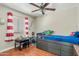 Bright bedroom featuring a ceiling fan, hardwood floors, and playful decor at 1331 E Bates St, Mesa, AZ 85203