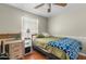 Cozy bedroom featuring hardwood floors, natural light, and a ceiling fan at 1331 E Bates St, Mesa, AZ 85203