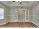 Spacious bonus room with wood floors, large window, and bright white trim at 1331 E Bates St, Mesa, AZ 85203