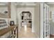 Welcoming foyer features wood look flooring, light walls, and an arched entryway with wooden beam at 1331 E Bates St, Mesa, AZ 85203