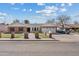 Charming single-story brick home featuring mature landscaping, a two-car garage, and inviting curb appeal at 1331 E Bates St, Mesa, AZ 85203