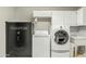 Practical laundry room with washer, dryer, utility sink, and abundant storage at 1331 E Bates St, Mesa, AZ 85203
