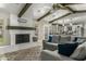 View of the painted brick fireplace and cozy seating area of the light and bright living room at 1331 E Bates St, Mesa, AZ 85203