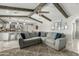Living room flows into the kitchen, creating an inviting space, with exposed beams on the vaulted ceiling at 1331 E Bates St, Mesa, AZ 85203