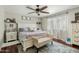 This main bedroom features a ceiling fan, dark wood floors, and natural light at 1331 E Bates St, Mesa, AZ 85203