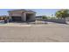 Medium shot view of the front of the home with gated parking, two garage entrances, and a putting green at 1373 E 23Rd Ave, Apache Junction, AZ 85119