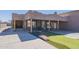 Close shot view of the front of the home and outdoor entertainment area with artificial grass and stonework at 1373 E 23Rd Ave, Apache Junction, AZ 85119