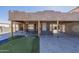 Exterior of home with seating area, putting green and rustic columns at 1373 E 23Rd Ave, Apache Junction, AZ 85119