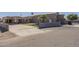 Long shot view of the front of the home with a putting green, a gate and two entrances to the structure at 1373 E 23Rd Ave, Apache Junction, AZ 85119