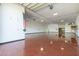 Spacious garage with a bright red floor, an American flag on the wall and a shelving unit along the back wall at 1373 E 23Rd Ave, Apache Junction, AZ 85119