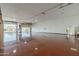 Spacious garage interior with painted floor and roll up door partially opened at 1373 E 23Rd Ave, Apache Junction, AZ 85119
