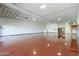 Large garage with a red painted floor, a door and shelves for storage at 1373 E 23Rd Ave, Apache Junction, AZ 85119