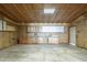 View of the garage with unfinished walls, plywood ceiling and cabinets for storage at 1373 E 23Rd Ave, Apache Junction, AZ 85119