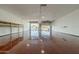 Large garage space with wooden shelves, open bay doors and a smooth floor, ready for various projects at 1373 E 23Rd Ave, Apache Junction, AZ 85119