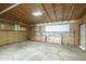 View of the garage with unfinished walls, plywood ceiling and cabinets for storage at 1373 E 23Rd Ave, Apache Junction, AZ 85119