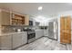 Kitchen features stainless appliances, gray cabinets and mosaic backsplash at 1373 E 23Rd Ave, Apache Junction, AZ 85119