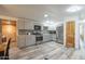Modern eat-in kitchen with stainless steel appliances, wood-look flooring, and plentiful cabinet space at 1373 E 23Rd Ave, Apache Junction, AZ 85119
