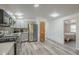 A sleek, modern kitchen with stainless steel appliances, grey cabinetry, mosaic tile backsplash, and wood-look floors at 1373 E 23Rd Ave, Apache Junction, AZ 85119