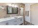Bathroom featuring a double sink vanity, large mirror, and wood-look tile floors at 15056 N 43Rd St, Phoenix, AZ 85032