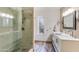 Bathroom featuring a double sink vanity, walk-in shower, and wood-look tile floors at 15056 N 43Rd St, Phoenix, AZ 85032