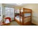 Bedroom with a bunk bed, ceiling fan, and natural light at 15056 N 43Rd St, Phoenix, AZ 85032