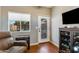 Comfortable bonus room with TV, display cabinet, tool chest, and view of the backyard at 15056 N 43Rd St, Phoenix, AZ 85032