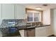 Updated kitchen with stainless steel appliances, dark countertops, tile backsplash, and stainless steel sink at 15056 N 43Rd St, Phoenix, AZ 85032