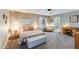 Spacious main bedroom with a ceiling fan, carpet floors, a desk, and lots of natural light at 15056 N 43Rd St, Phoenix, AZ 85032