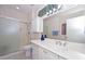 Bathroom featuring a vanity with dual sinks and glass enclosed shower at 15779 W Remington Dr, Surprise, AZ 85374
