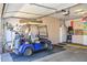 Garage featuring storage cabinets, golf cart, bicycle and golf clubs at 15779 W Remington Dr, Surprise, AZ 85374