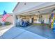 Garage with golf cart, bicycle and golf clubs in front of storage cabinets at 15779 W Remington Dr, Surprise, AZ 85374