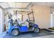 Garage featuring a golf cart and storage cabinets at 15779 W Remington Dr, Surprise, AZ 85374