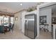 Open eat-in kitchen boasts stainless steel appliances and tiled floors at 15779 W Remington Dr, Surprise, AZ 85374