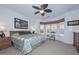Bright main bedroom with ceiling fan and large windows for natural light at 15779 W Remington Dr, Surprise, AZ 85374