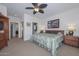 Spacious main bedroom with an open doorway leading to the ensuite bathroom at 15779 W Remington Dr, Surprise, AZ 85374