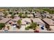 Expansive aerial view showcasing a residential neighborhood with uniform houses and well-kept landscaping at 16188 W Hearn Rd, Surprise, AZ 85379