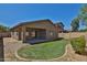 Backyard featuring a covered patio, gravel, grass, and a block wall at 16188 W Hearn Rd, Surprise, AZ 85379