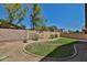 Backyard featuring grass, desert landscaping, and a block wall at 16188 W Hearn Rd, Surprise, AZ 85379