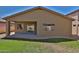 Backyard featuring a covered patio, gravel, grass, and desert landscaping at 16188 W Hearn Rd, Surprise, AZ 85379