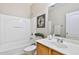 Bright bathroom with a shower-tub combination, a single sink vanity and decorative mirror at 16188 W Hearn Rd, Surprise, AZ 85379