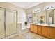 Bright bathroom featuring a walk-in shower, soaking tub, and a dual sink vanity at 16188 W Hearn Rd, Surprise, AZ 85379