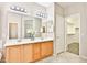 Bathroom featuring a walk-in closet, dual sink vanity, and tile floors at 16188 W Hearn Rd, Surprise, AZ 85379