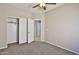 Inviting bedroom with a ceiling fan, neutral walls, plush carpet and a convenient closet at 16188 W Hearn Rd, Surprise, AZ 85379