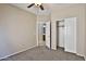Relaxing bedroom with a ceiling fan, plush carpet, access to a bathroom and a closet at 16188 W Hearn Rd, Surprise, AZ 85379