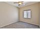 Comfortable bedroom featuring a ceiling fan, plush carpet, and neutral walls with a window view at 16188 W Hearn Rd, Surprise, AZ 85379