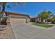 Charming single-story home featuring a two-car garage, desert landscaping, and a well-maintained lawn at 16188 W Hearn Rd, Surprise, AZ 85379
